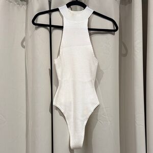 Elegant White womens bodysuit with small stains